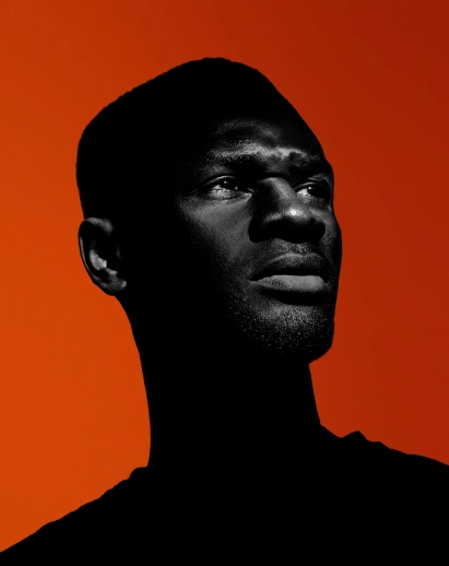 Portrait of a man with a determined look on a orange background