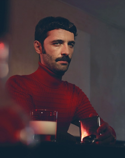 Portrait of a man with a turtleneck in a bar
